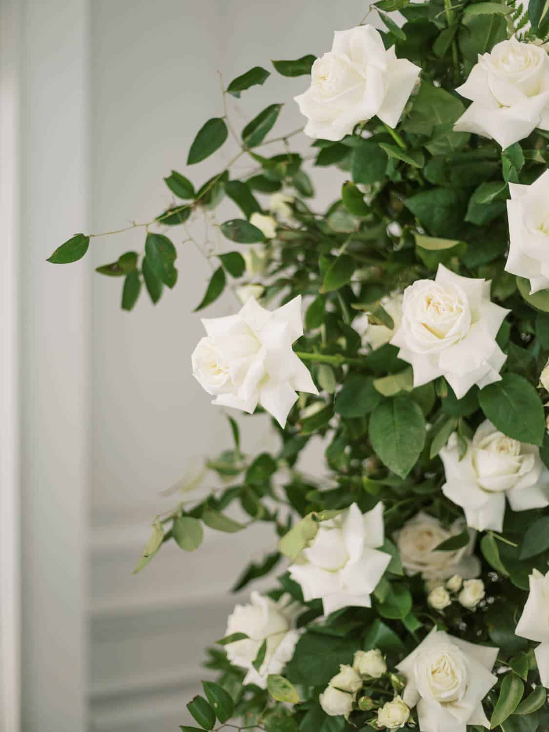White roses and greenery for floral decoration.