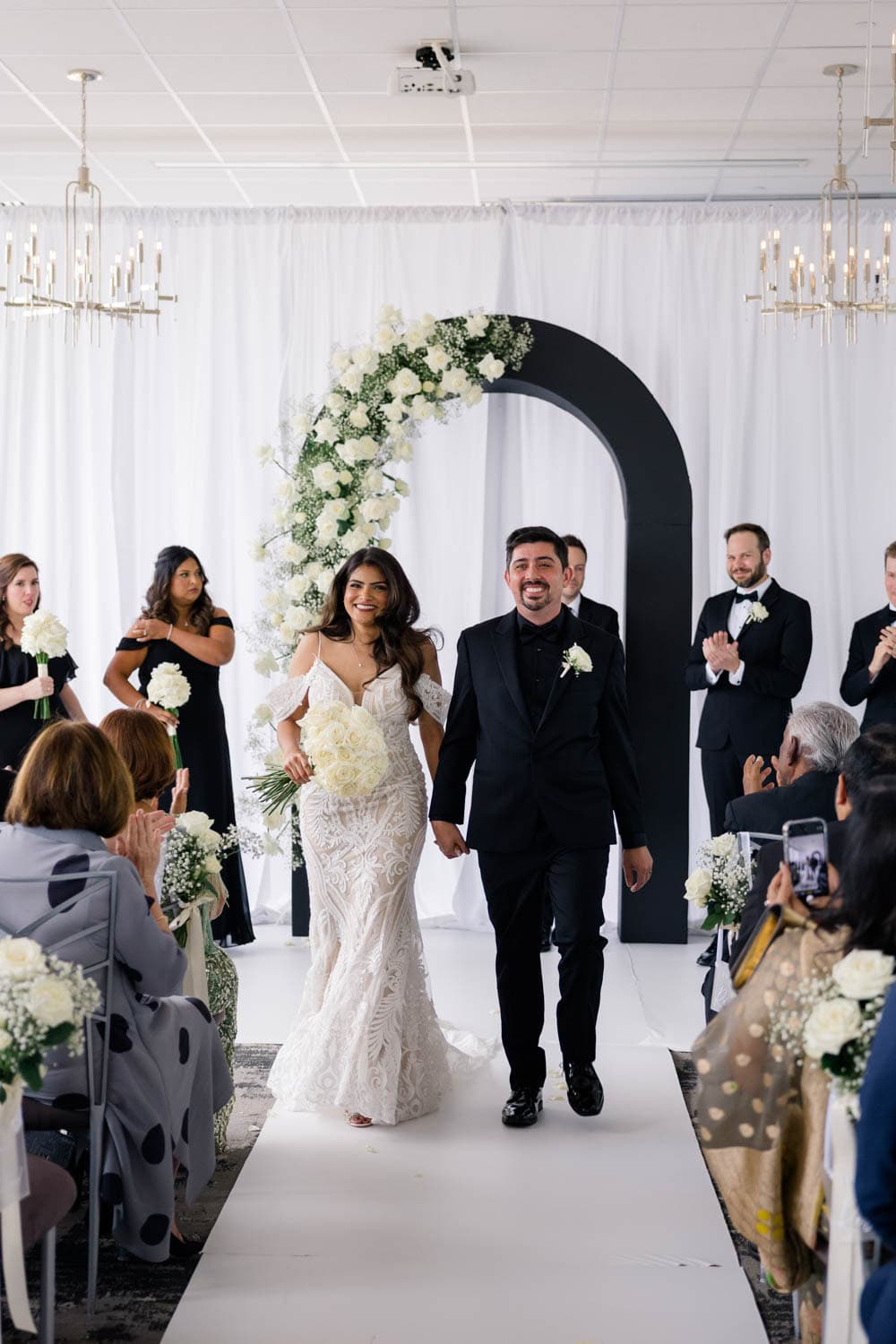 Wedding floral arrangements with elegant white roses and greenery.