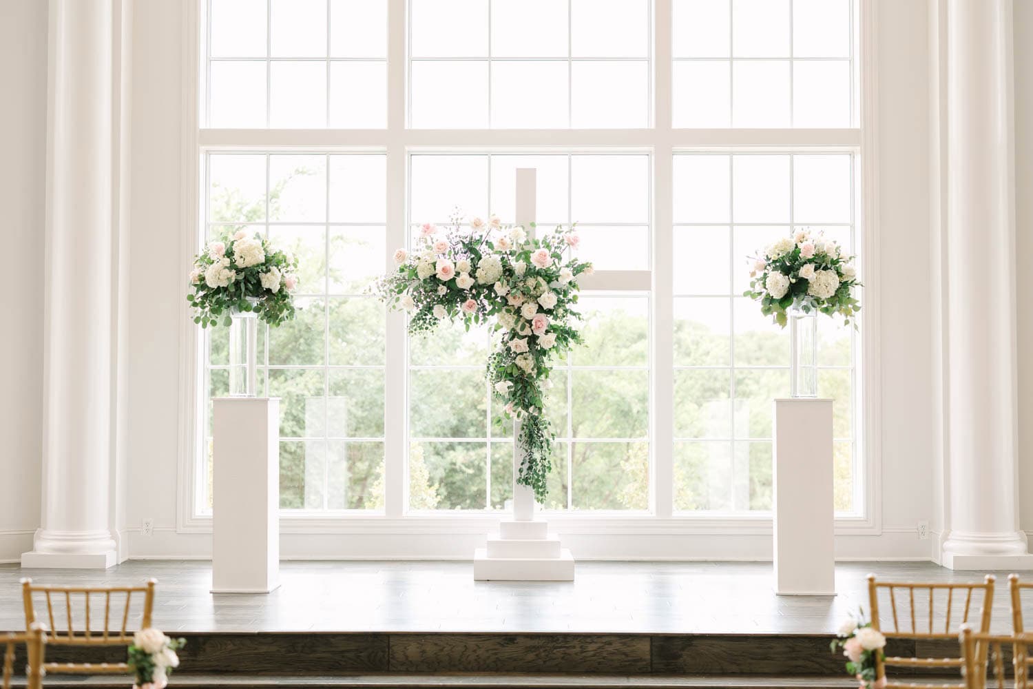 Beautiful wedding floral arrangement with white and pink flowers in a bright, airy venue.