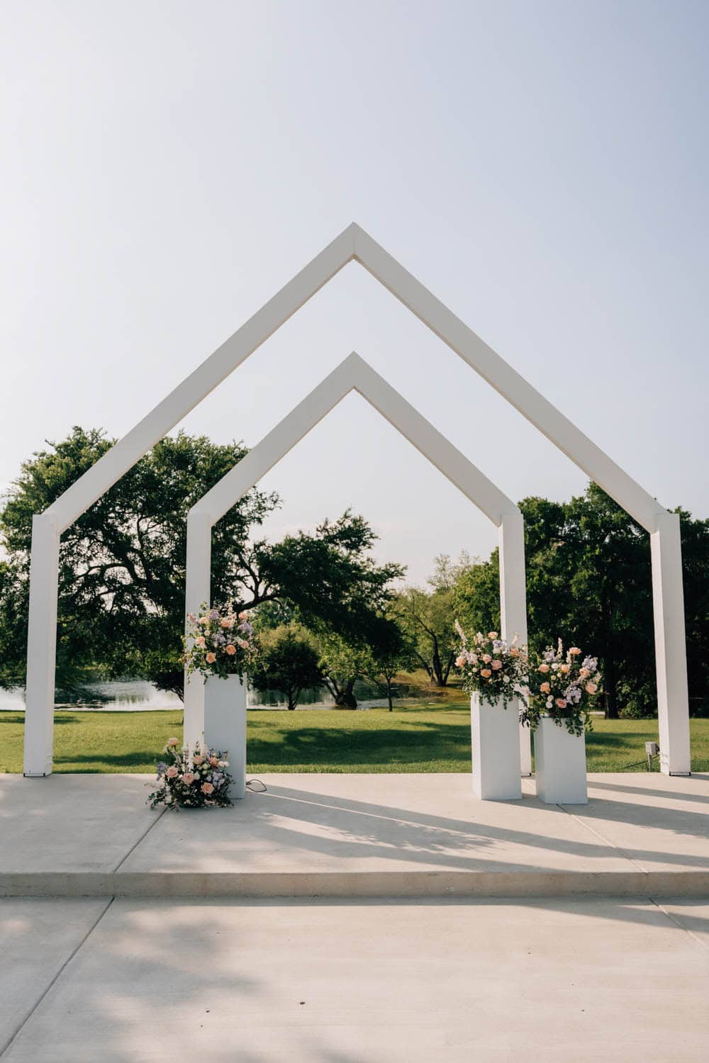 Beautiful floral arch with pink and white flowers for wedding ceremonies.