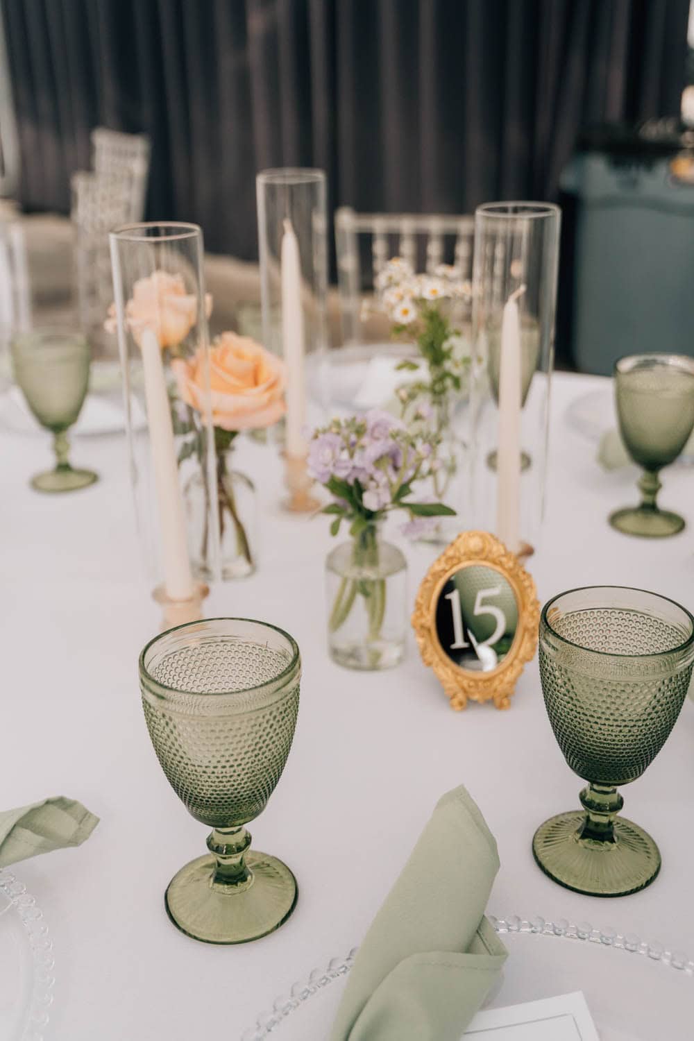 Elegant floral table centerpiece with roses and greenery for special events.