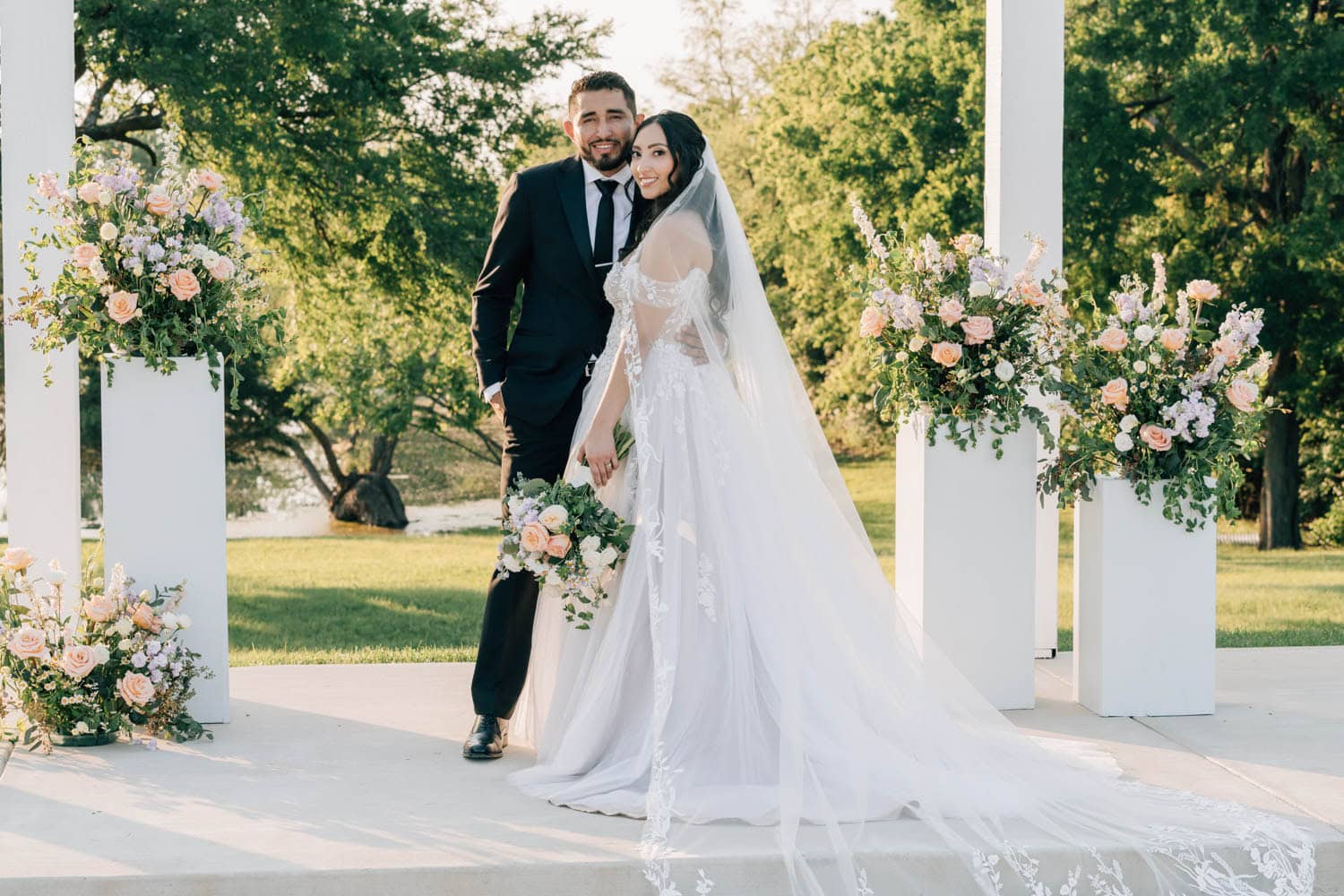 Elegant wedding floral arrangements with roses and greenery.