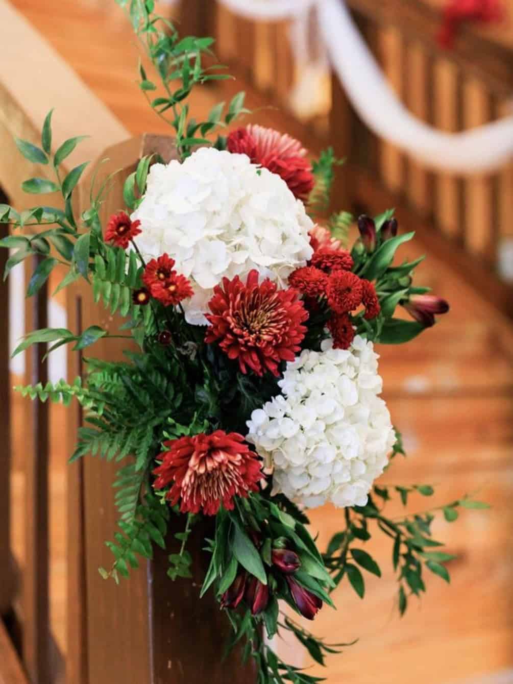 Beautiful floral bouquet featuring red and white hydrangeas with greenery accents.