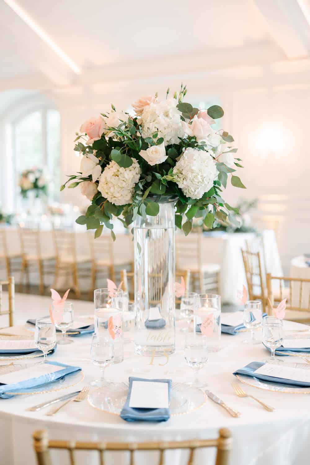 Beautiful floral centerpiece featuring white and blush roses, hydrangeas, and greenery for wedding d.