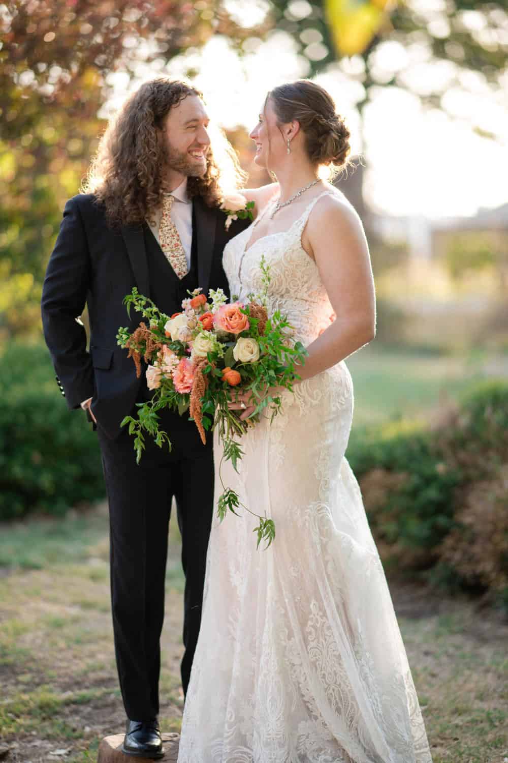 Beautiful wedding bouquet with roses and greenery at outdoor wedding.
