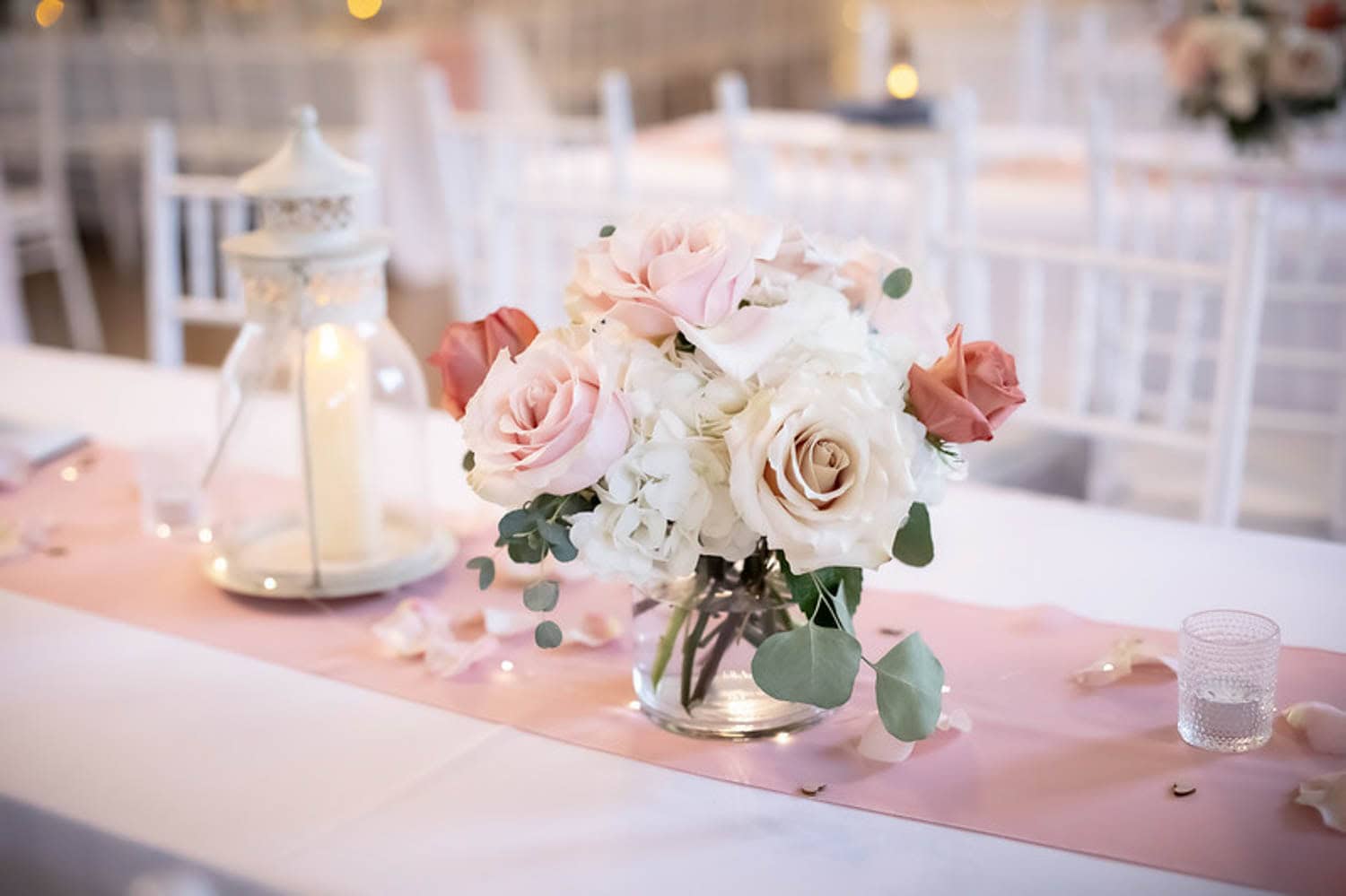 Beautiful blush and white roses floral arrangement for wedding decor.