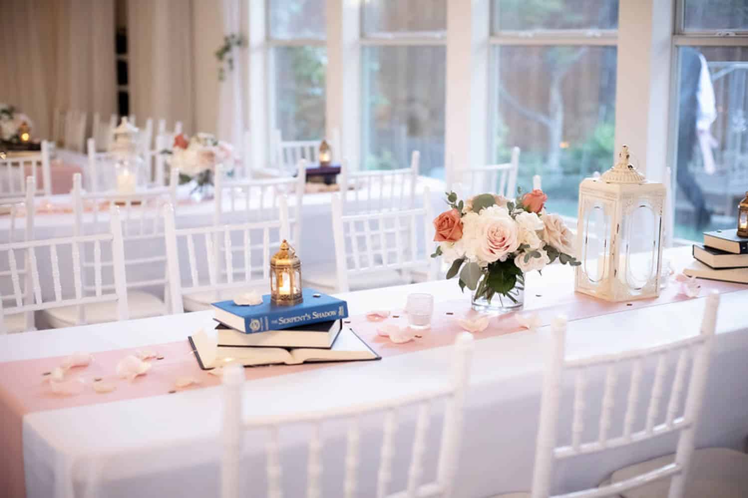 Beautiful floral arrangement with roses and greenery for wedding table decor.