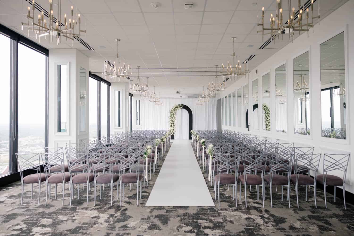 Elegant wedding ceremony setup with floral accents and modern decor.